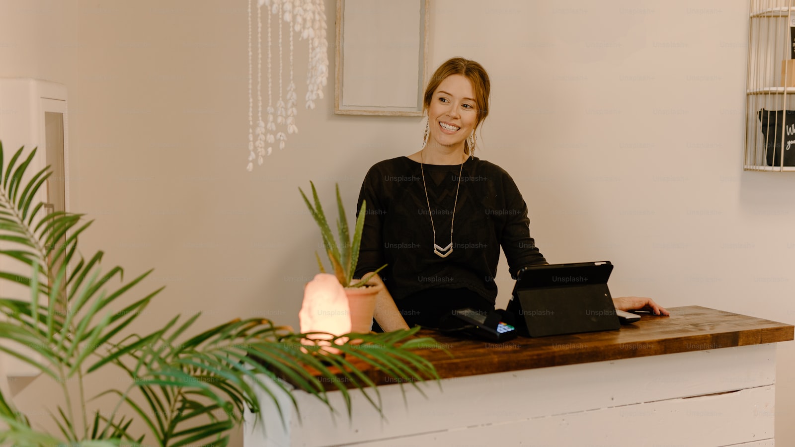A woman working at a desk with a laptop