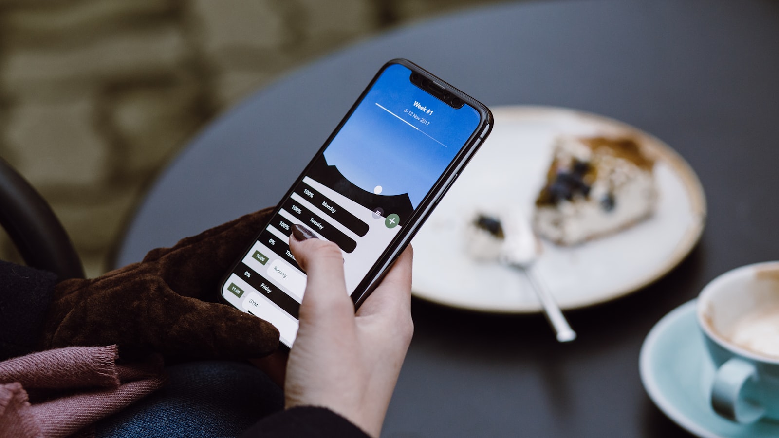Close-up of hands typing a message on a smartphone