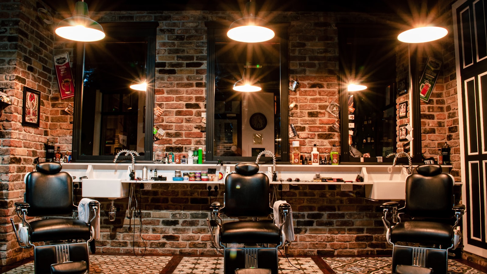 A black leather barber chair by a brick wall
