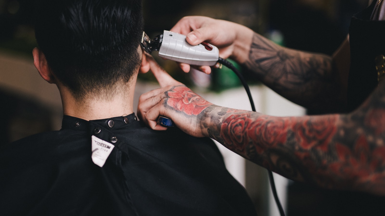 A barber using clippers on a client's hair