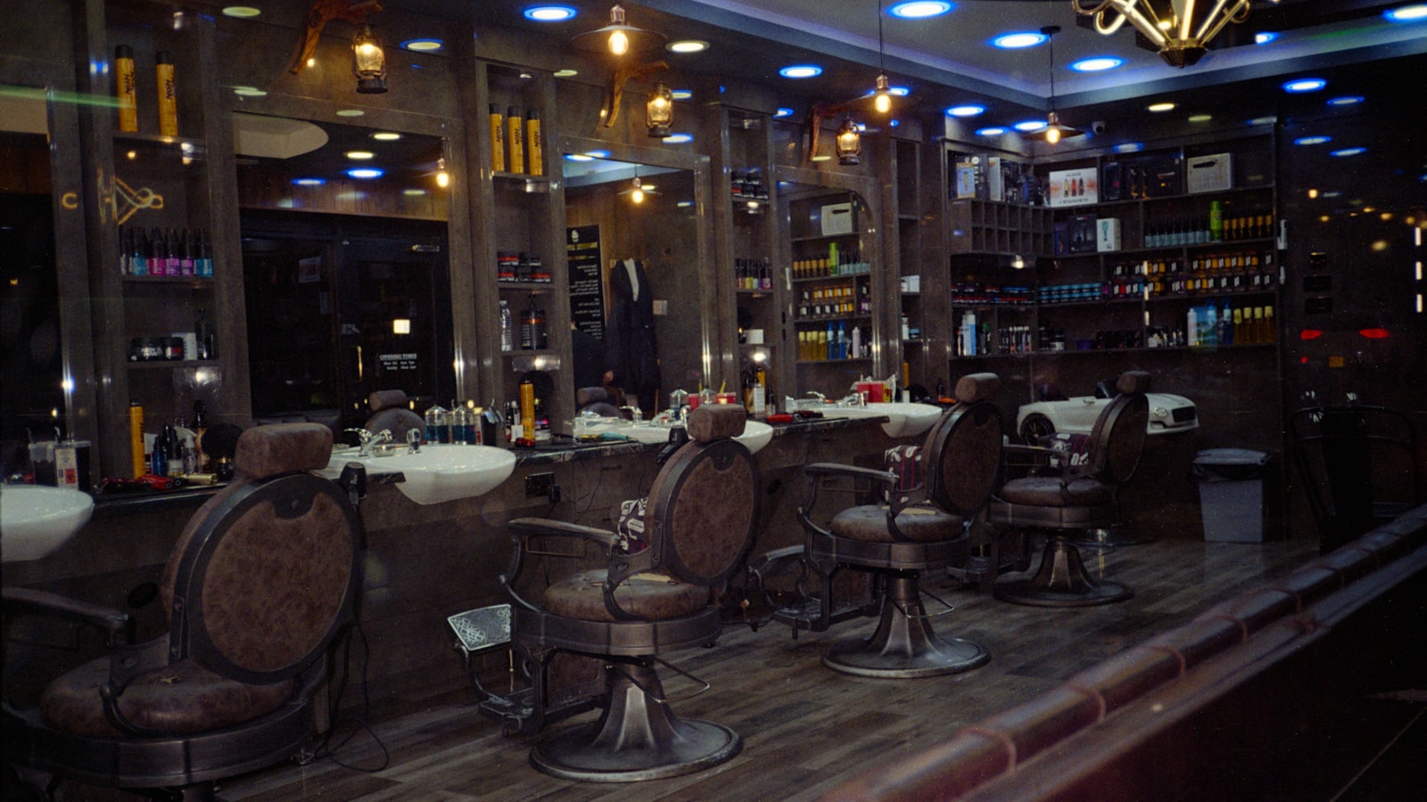 Vintage leather barber chairs in a mirrored barbershop