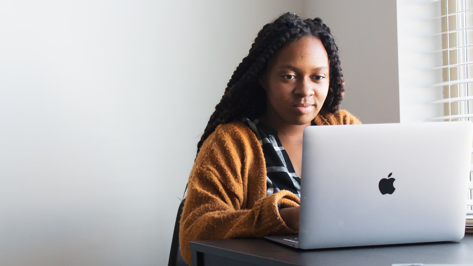 A woman typing on a laptop at a desk