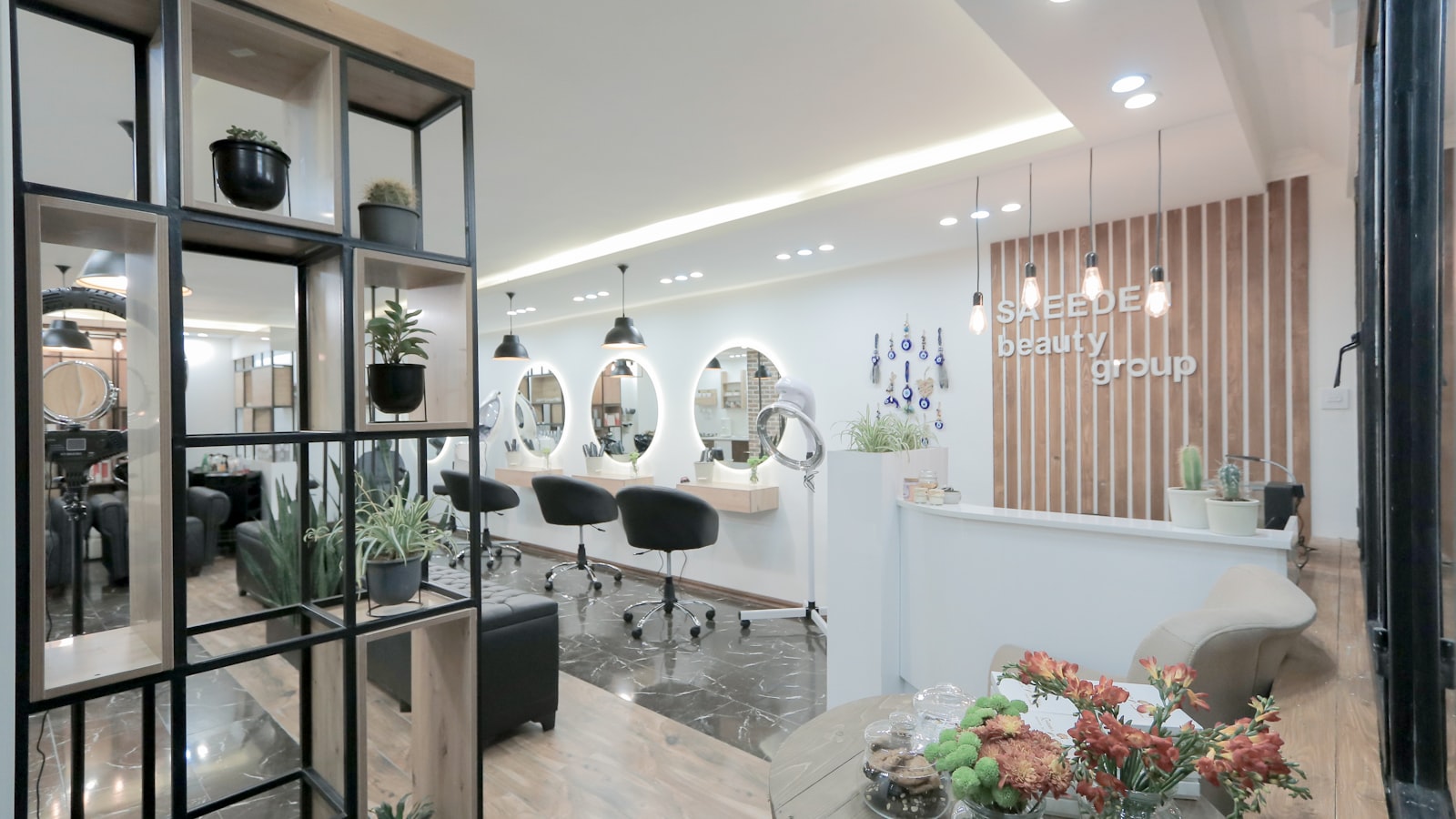 A bright salon interior with styling chairs and a reception desk